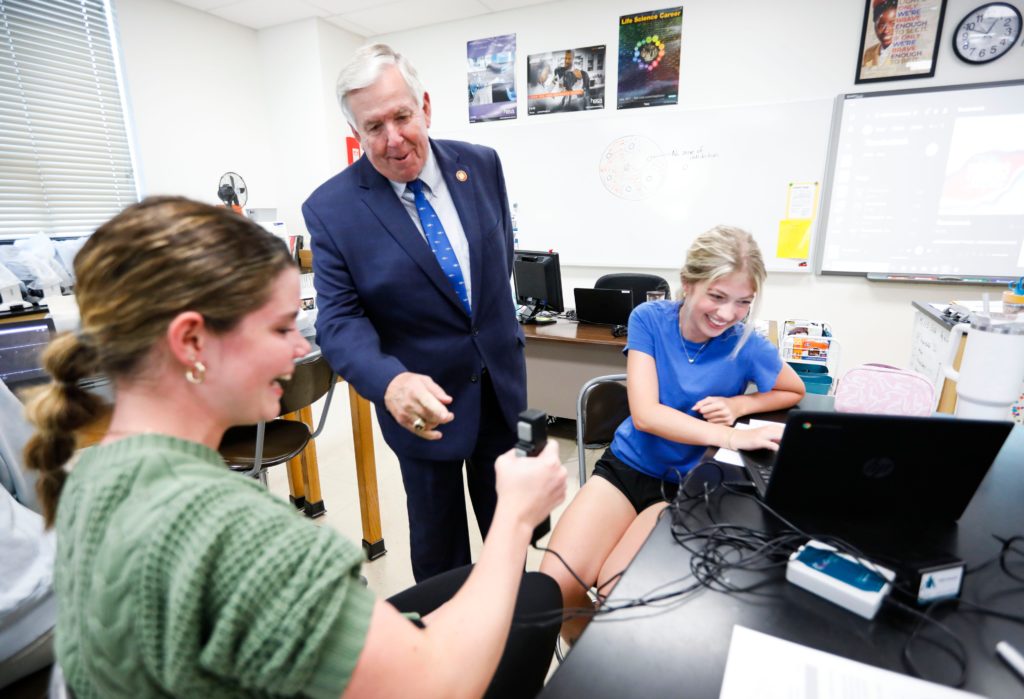 Kickapoo juniors Katie Cupp (left) and Alexa McCroskey talk with Missouri Governor Mike Parson as he takes a tour of Kickapoo