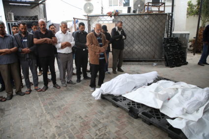 Mourners react next to the bodies of Palestinians killed in Israeli strikes, in Rafah