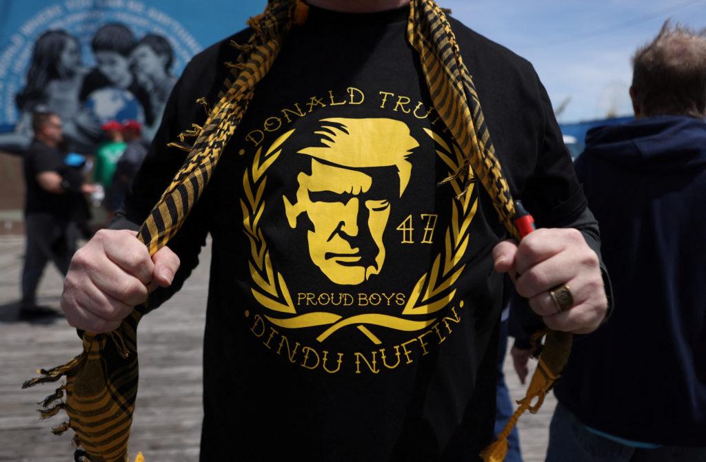 A view of a t-shirt worn by a member of the far-right Proud Boys as they arrive at a campaign rally for former U.S. presid...