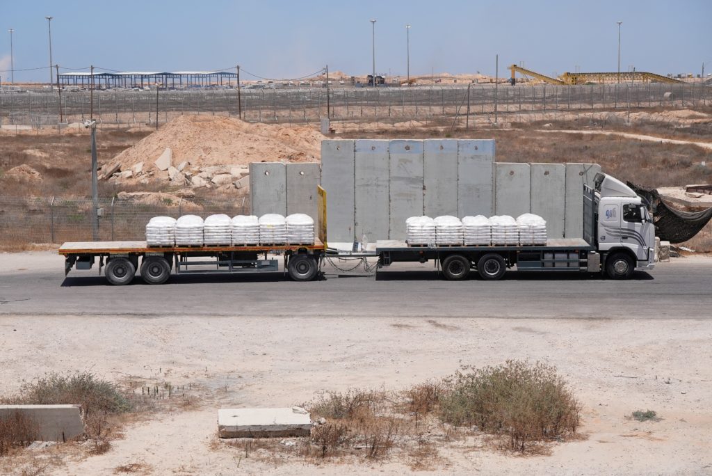 A truck carrying aid for delivery into Gaza drives through the Kerem Shalom crossing in southern Israel