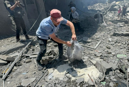 Palestinians search for casualties at the site of Israeli strikes on houses, in Gaza City
