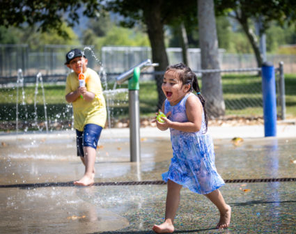 Kids cool off in a spray park amid the heat at Rio de Los Angeles Park