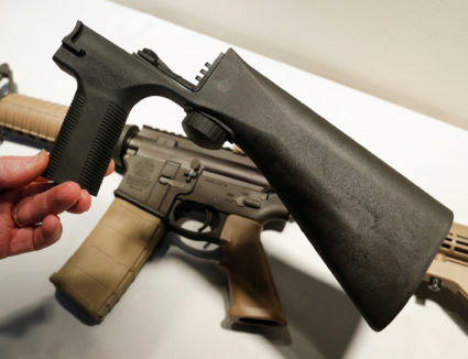 A bump fire stock that attaches to a semi-automatic rifle to increase the firing rate is seen at Good Guys Gun Shop in Orem