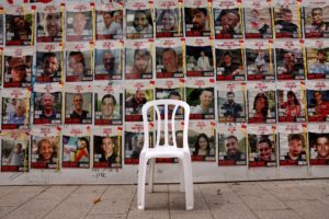 Chair is left in front of posters with pictures of hostages who were kidnapped during the deadly October 7 attack on Israe...