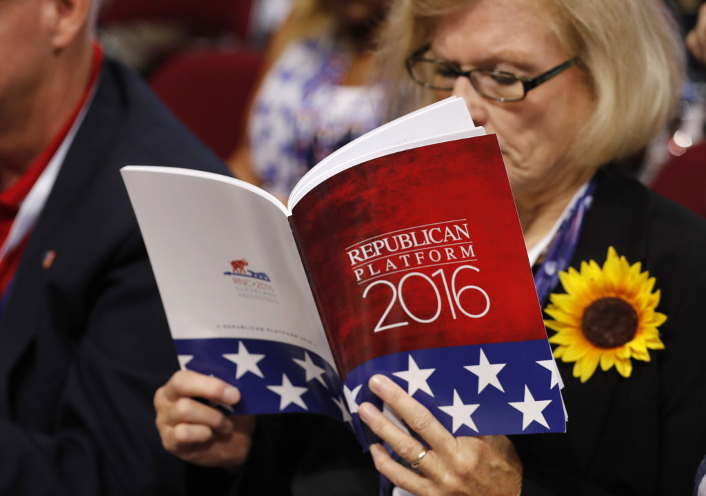 A delegate studies a copy of the Republican platform document at the Republican National Convention in Cleveland