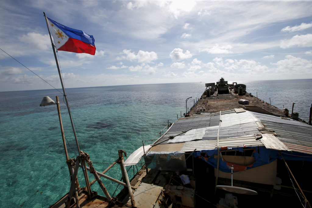 A Philippine flag flutters from BRP Sierra Madre, a dilapidated Philippine Navy ship that has been aground since 1999 and ...