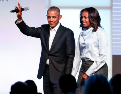 Former U.S. President Barack Obama and former first lady Michelle Obama greet guests during the Obama Foundation Summit in...
