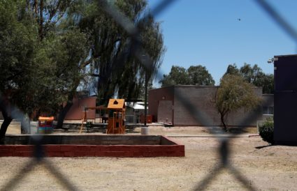A playground is seen through chain link fencing as U.S. first lady tours immigration detention facility for children in Ph...