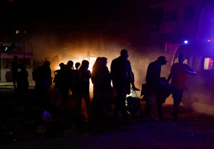Palestinians, who fled the eastern part of Khan Younis, walk, after they were ordered by Israeli army to evacuate their ne...
