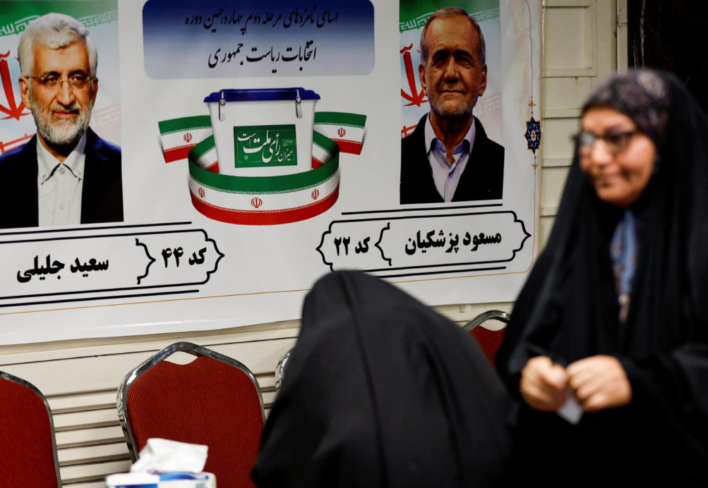 Iranian voters participate in the run-off presidential election between Masoud Pezeshkian and Saeed Jalili,at the Iranian ...