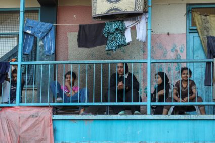 Palestinians react, after an Israeli air strike on a UN school sheltering displaced people, amid the Israel-Hamas conflict...