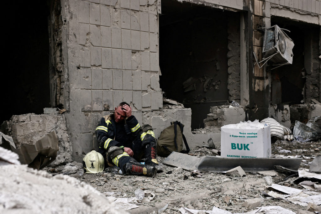 A rescuer reacts at Ohmatdyt Children's Hospital after it was damaged during Russian missile strikes, in Kyiv