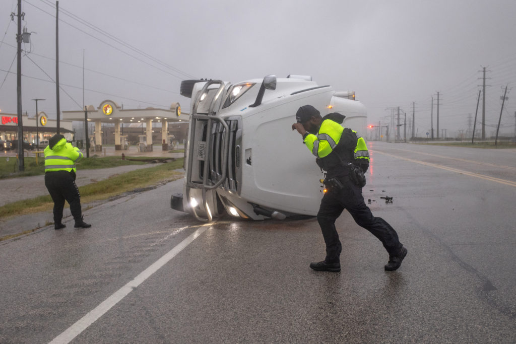 Police search overturned semi-trailer truck in aftermath of Hurricane Beryl in Freeport, Texas