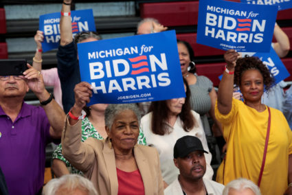 People hold placards in support of U.S. President Joe Biden during a campaign stop in Detroit
