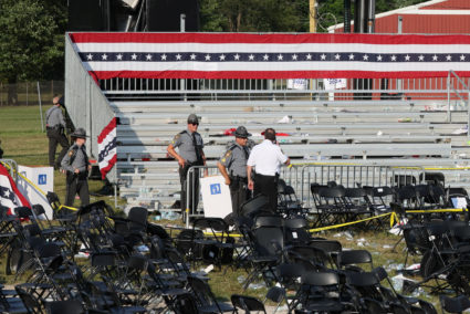 Security personnel inspect the site after gunfire rang out during a campaign rally in Butler