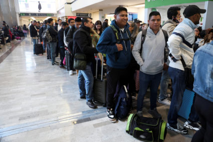 Passengers wait at the Benito Juarez International Airport due to a worldwide tech outage that caused flight delays, in Me...