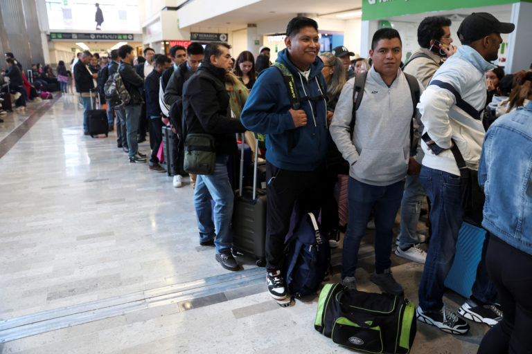 Passengers wait at the Benito Juarez International Airport due to a worldwide tech outage that caused flight delays, in Me...