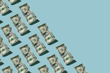 Crumpled one dollar bills on blue background