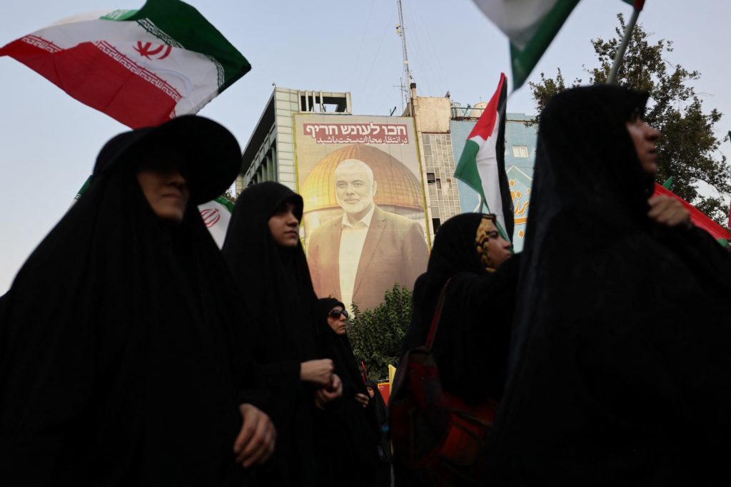 A billboard with a picture of Palestinian group Hamas' top leader Ismail Haniyeh, is displayed during an anti-Israel gathe...
