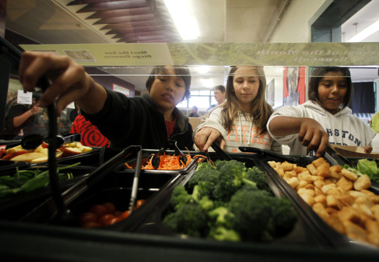Students get their lunch from a salad bar at the school cafeteria as some of more than 8,000lbs of locally grown broccoli ...