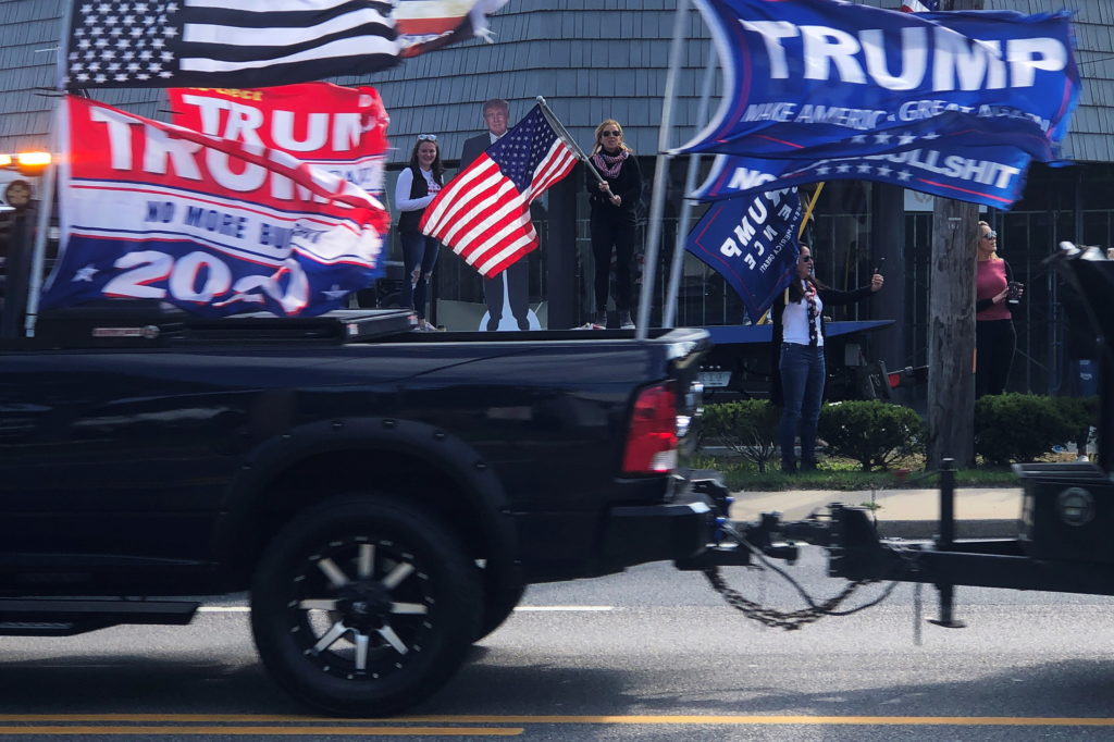 Supporters of U.S. President Donald Trump cheer as a rolling rally for the president makes its way through Southampton, Ne...