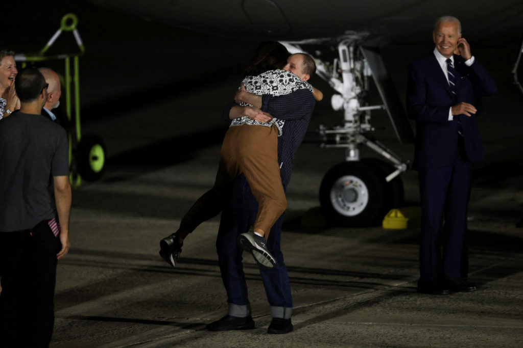 U.S. President Joe Biden looks on as Evan Gershkovich who was released from detention in Russia, is greeted by his mother ...