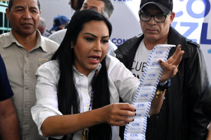 Venezuelan opposition lawmaker Delsa Solorzano shows an electoral tally during a press conference in Caracas