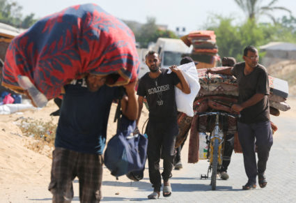 Displaced Palestinians make their way as they flee Hamad City following an Israeli evacuation order, in Khan Younis in the...