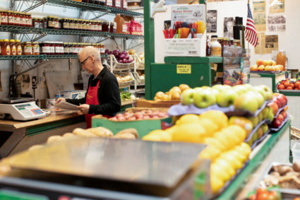 FILE PHOTO: People shop for groceries at Eastern Market in Washington