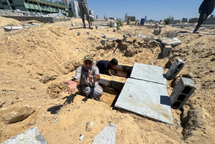 Palestinians prepare graves in a cemetery as death toll surpasses 40,000