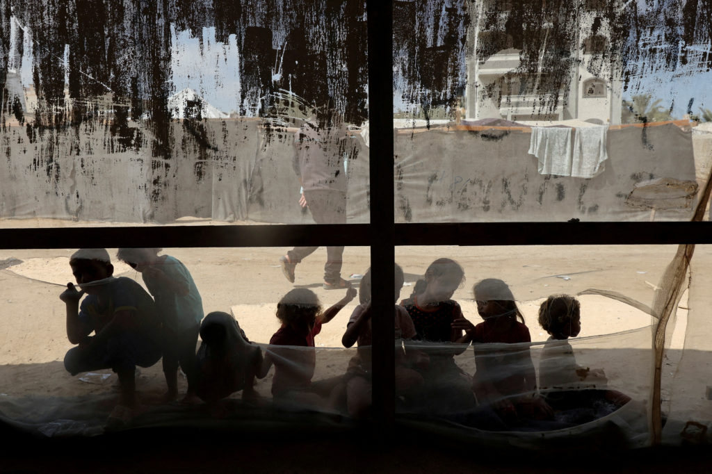 FILE PHOTO: Palestinian children play outside a medical tent in Deir Al-Balah
