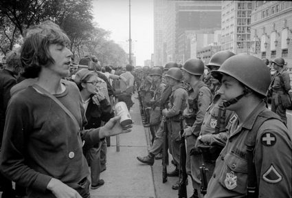 A demonstrator stands in front of a row of National Guard soldiers