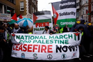 People protest demanding a ceasefire in Gaza during a march, in London