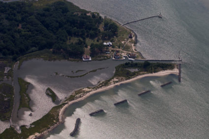 A partial seawall is seen near houses along the water's edge on Tangier Island