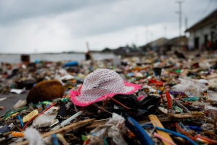 Indonesian fishing village grapples with piles of trash amid erratic high tides