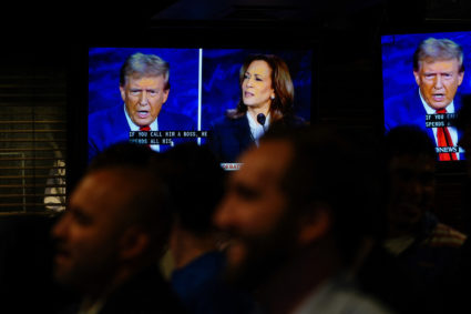People watch the presidential debate between Trump and Harris, in New York