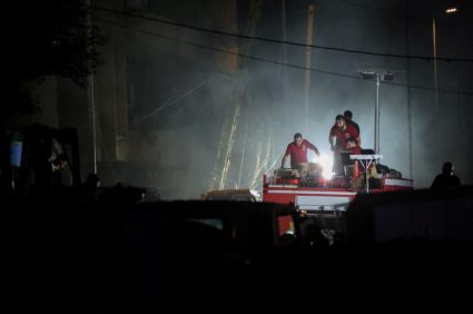 Civil Defense members work near the site of an Israeli strike in the southern suburbs of Beirut