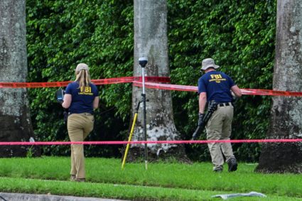 Members of the FBI investigate the area around Trump International Golf Club in West Palm Beach