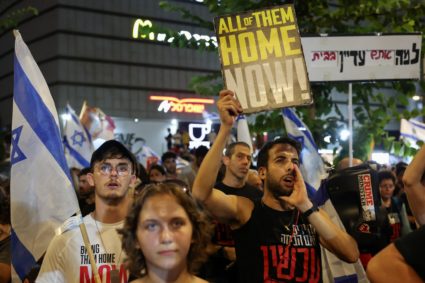 People gather to protest against the government and to show support for the hostages who were kidnapped during the deadly ...