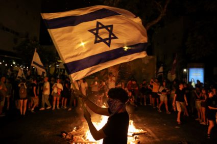 People rally to protest against the government and to show support for the hostages who were kidnapped during the deadly O...