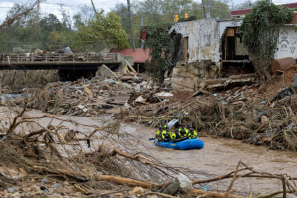 A rescue team paddles down the Swannanoa River