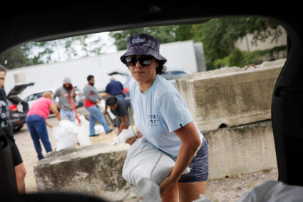 Valerie Jackson loads up an SUV with sandbags ahead of the arrival of Hurricane Milton