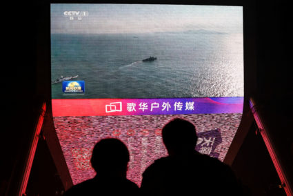 Screen shows news footage of military drills conducted in areas around the island of Taiwan by the Eastern Theatre Command...