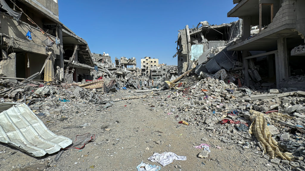 Palestinians view the damage after Israeli forces withdrew from the area around Kamal Adwan hospital, amid the ongoing Isr...