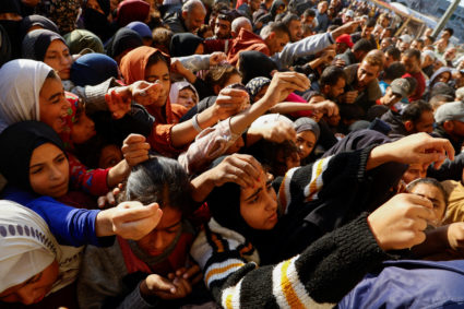 Palestinians gather to buy bread from a bakery, in Khan Younis, in the southern Gaza Strip