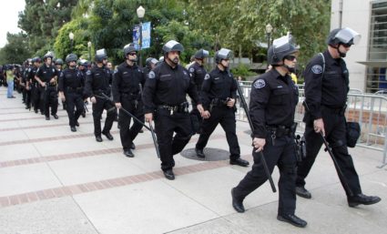 Law enforcement in riot gear arrive at the site of the UC Board of Regents meeting where students are demonstrating UCLA c...