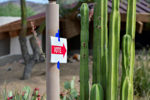 A vote sign is taped near cacti at a polling station at Paradise Valley Town Hall in Phoenix