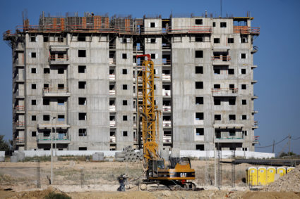 People work at a construction site in the Jewish settlement of Beit El, near Ramallah in the Israeli-occupied West Bank