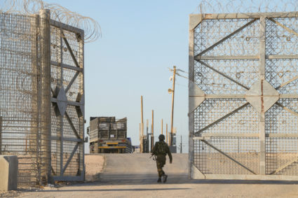 Trucks carrying humanitarian aid make their way to the Gaza Strip at Erez Crossing in southern Israel