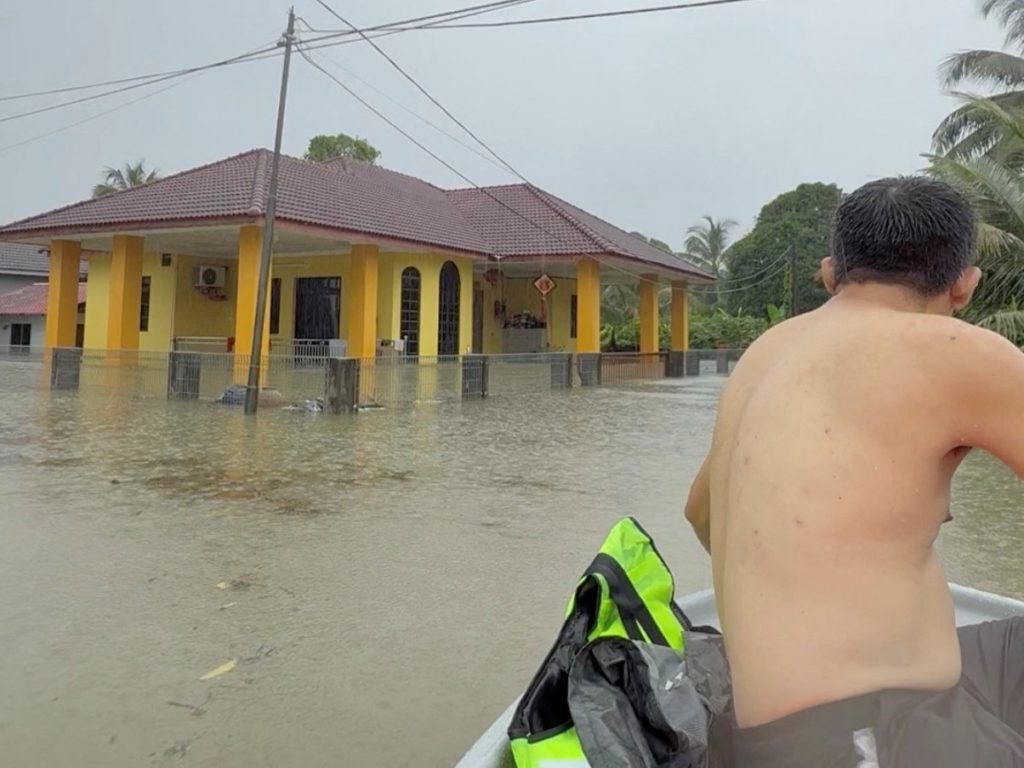 A view shows a partially submerged house in a flooded street in Melor, Kelantan, Malaysia, November 29, 2024, in this scre...